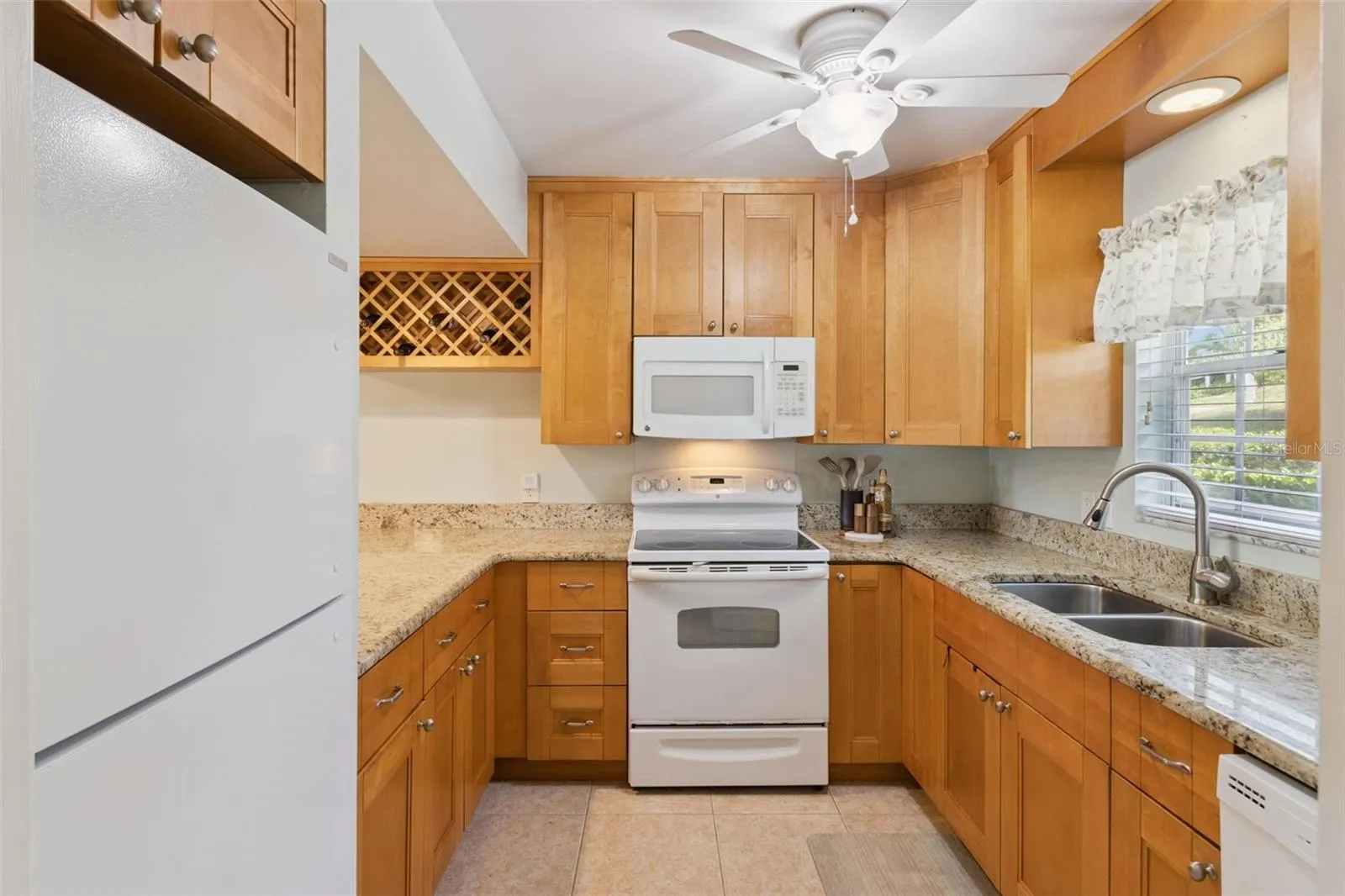 Richly endowed with gorgeous granite counters and a wealth of wood cabinets make this kitchen fun and functional.