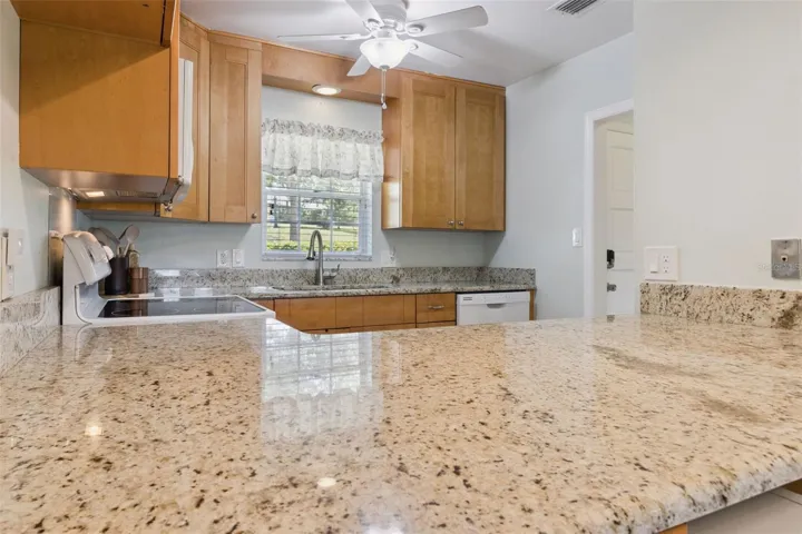 Abundant granite gleams throughout the kitchen.
