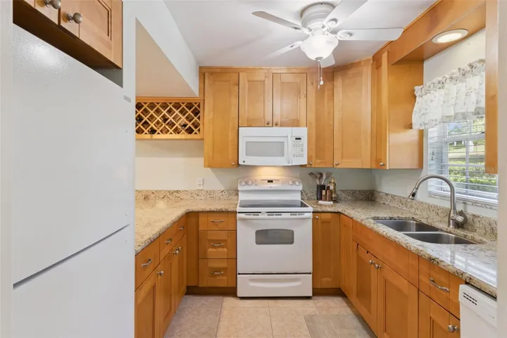 Richly endowed with gorgeous granite counters and a wealth of wood cabinets make this kitchen fun and functional.