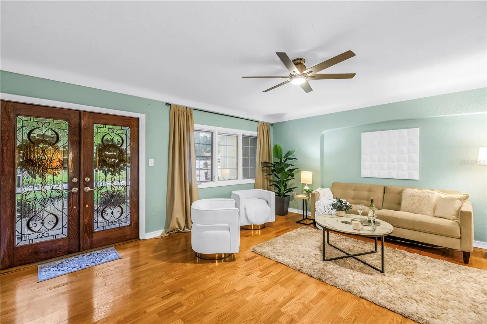 The formal living area, situated in one of St. Petersburg's most prestigious neighborhoods, offers an elegant space perfectly suited for greeting and entertaining guests.