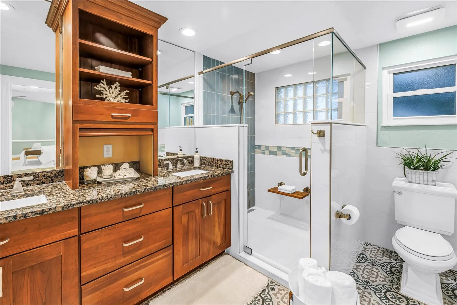 This primary bath is totally refreshed with new floors, totally updated step in shower. Dual granite vanity, upgraded cabinets and fixtures, plenty of storage, and a spacious walk-in linen closet.