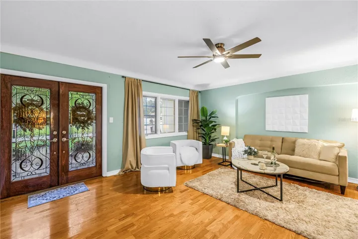 The formal living area, situated in one of St. Petersburg's most prestigious neighborhoods, offers an elegant space perfectly suited for greeting and entertaining guests.
