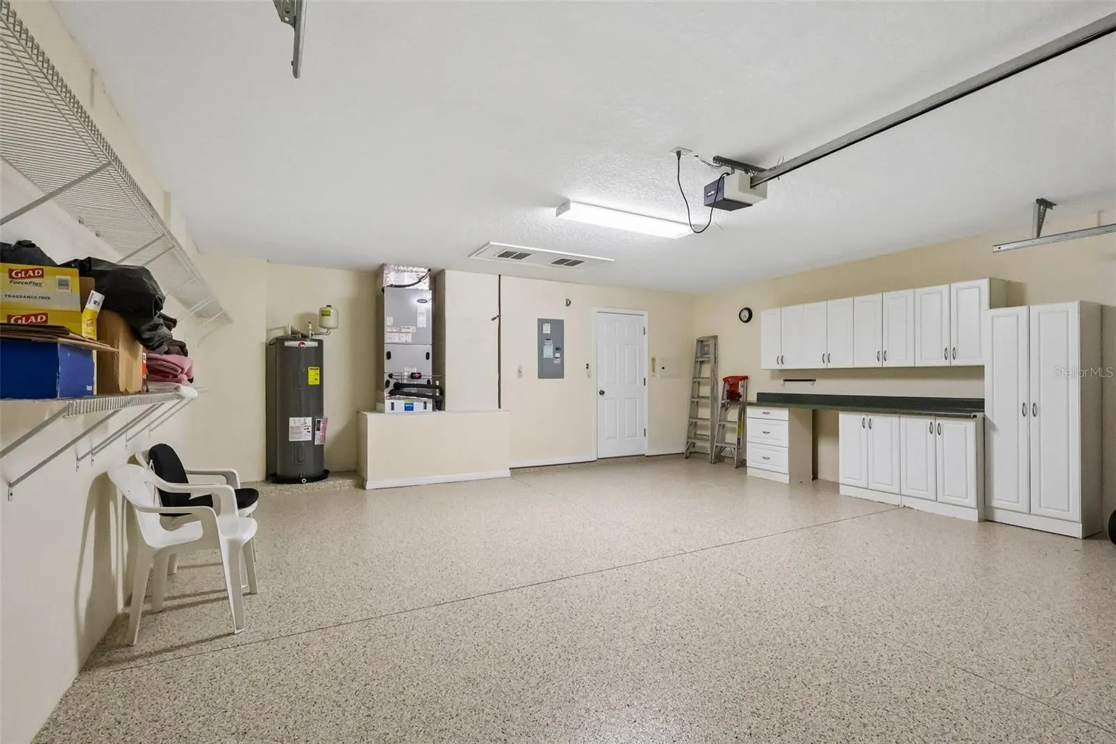 Freshly Painted Epoxy Garage Floor with Storage Cabinets and Workbench