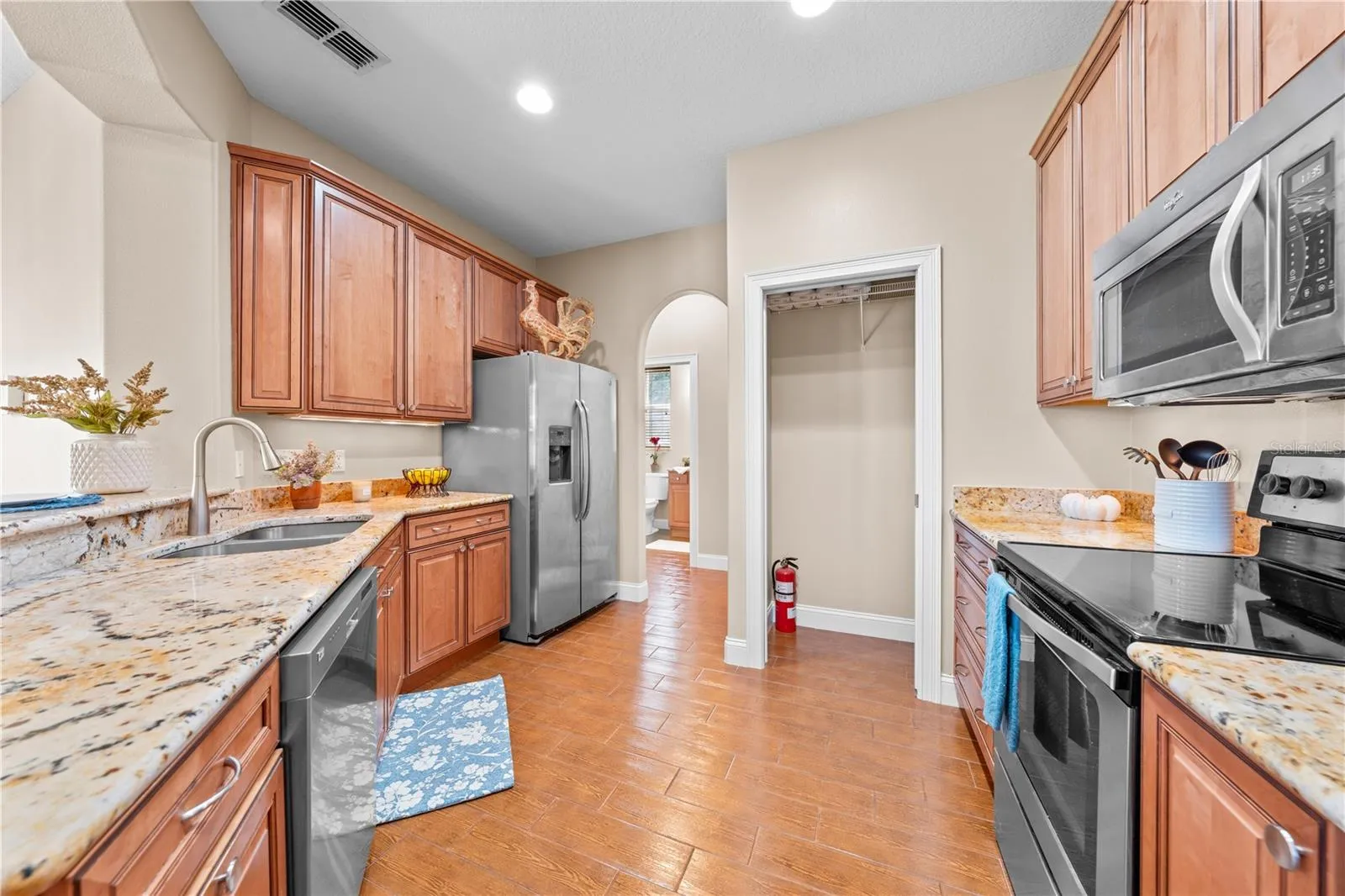 Stainless appliances and a large pantry.