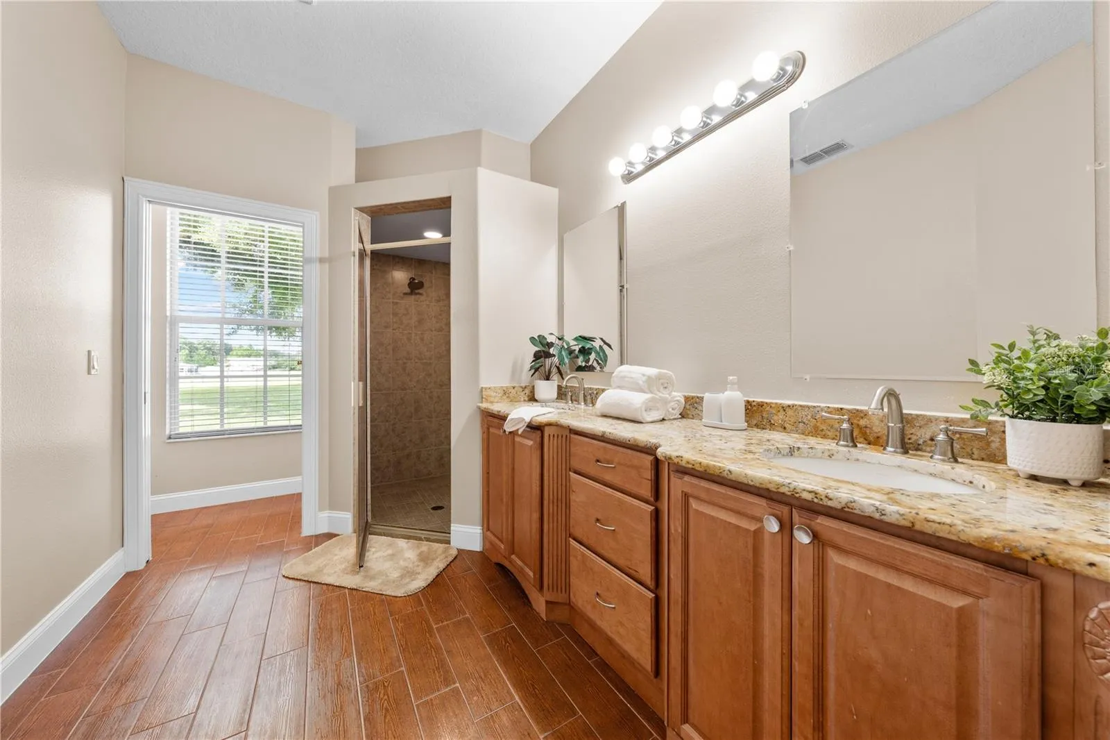 Primary Bathroom with Granite Countertops and double sinks.