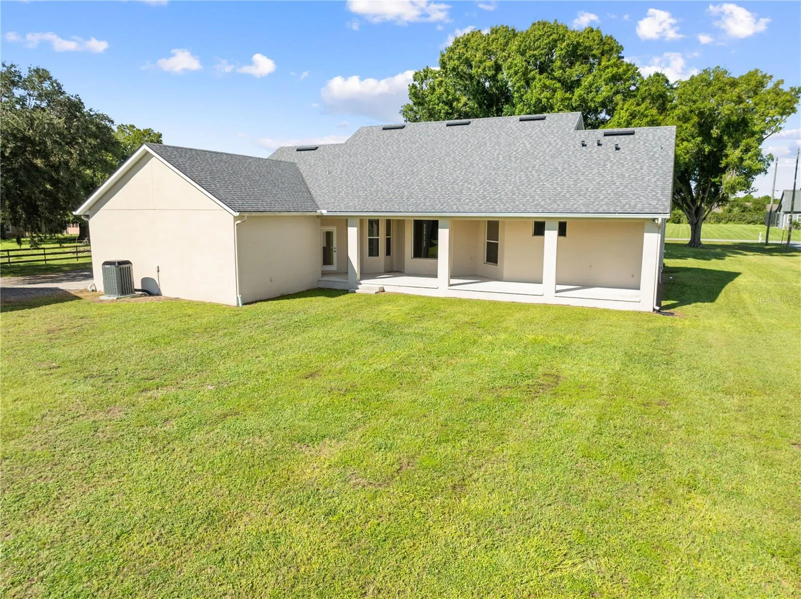 Exterior of the home with the covered back porch, plenty of space for a pool.