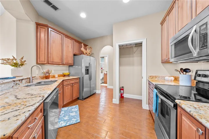 Stainless appliances and a large pantry.