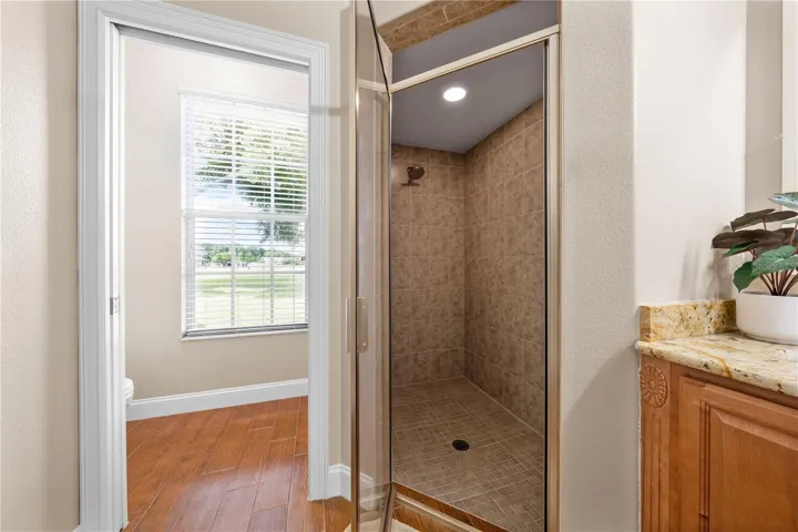 Primary Bathroom has a shower with rain-style showerhead and private door for the toilet.
