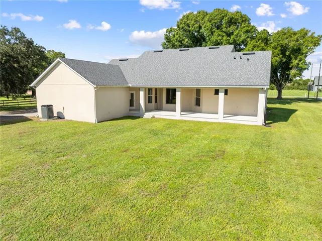 Exterior of the home with the covered back porch, plenty of space for a pool.