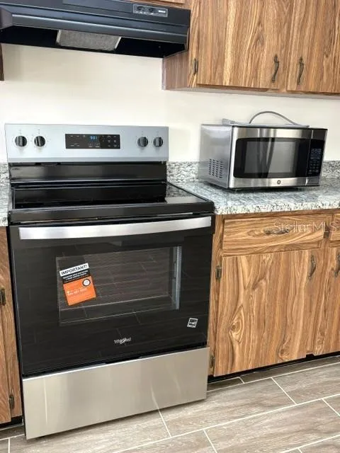 Whirlpool range with hood.