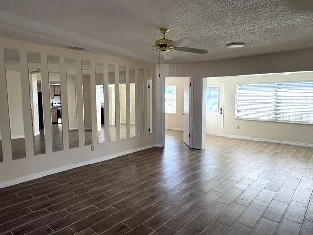 Living area with mirror accents to capture the natural light from the enclosed lanai.