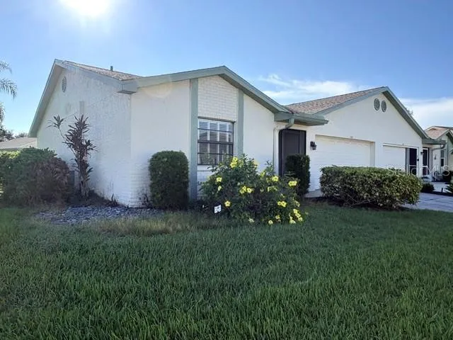 Lovely Florida landscaping on this corner lot.