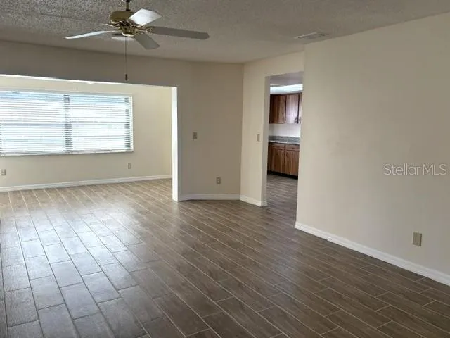 A welcoming living area, updated ceramic tile flooring throughout.  Beautiful natural light from the enclosed lanai.