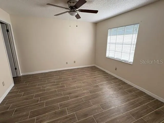 Primary bedroom with updated ceramic tile flooring.