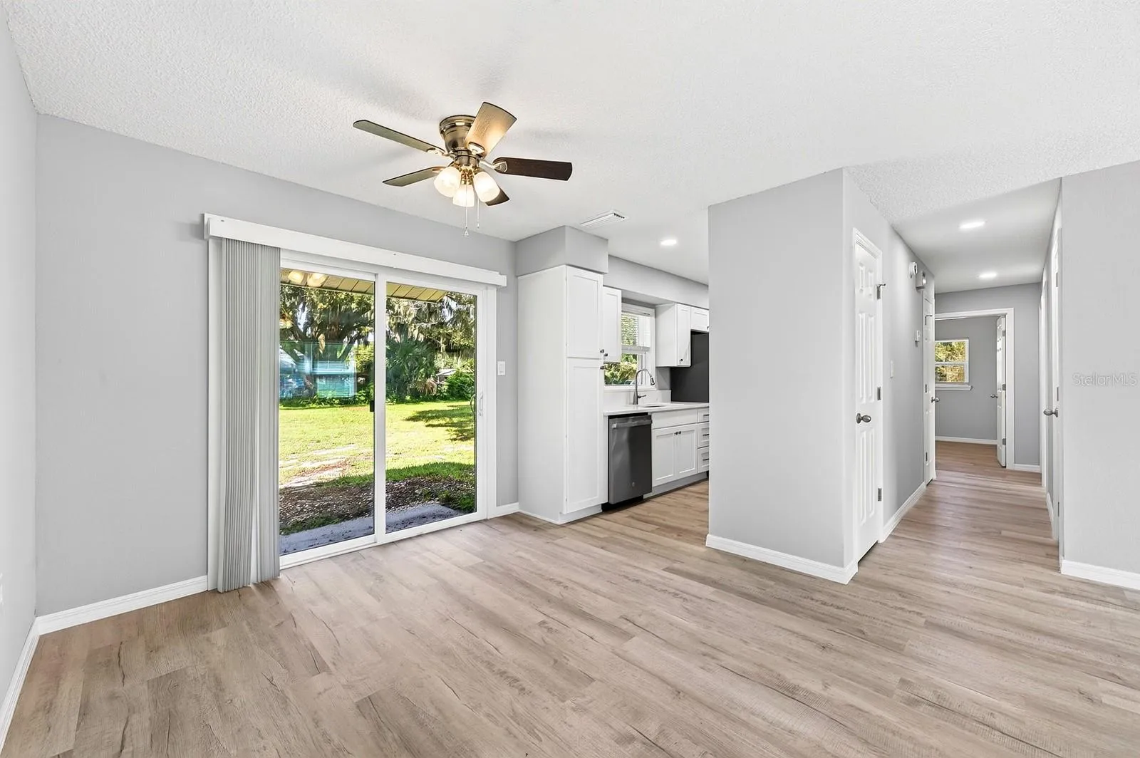 The Dining room opens into the kitchen with sliding glass door to the backyard.