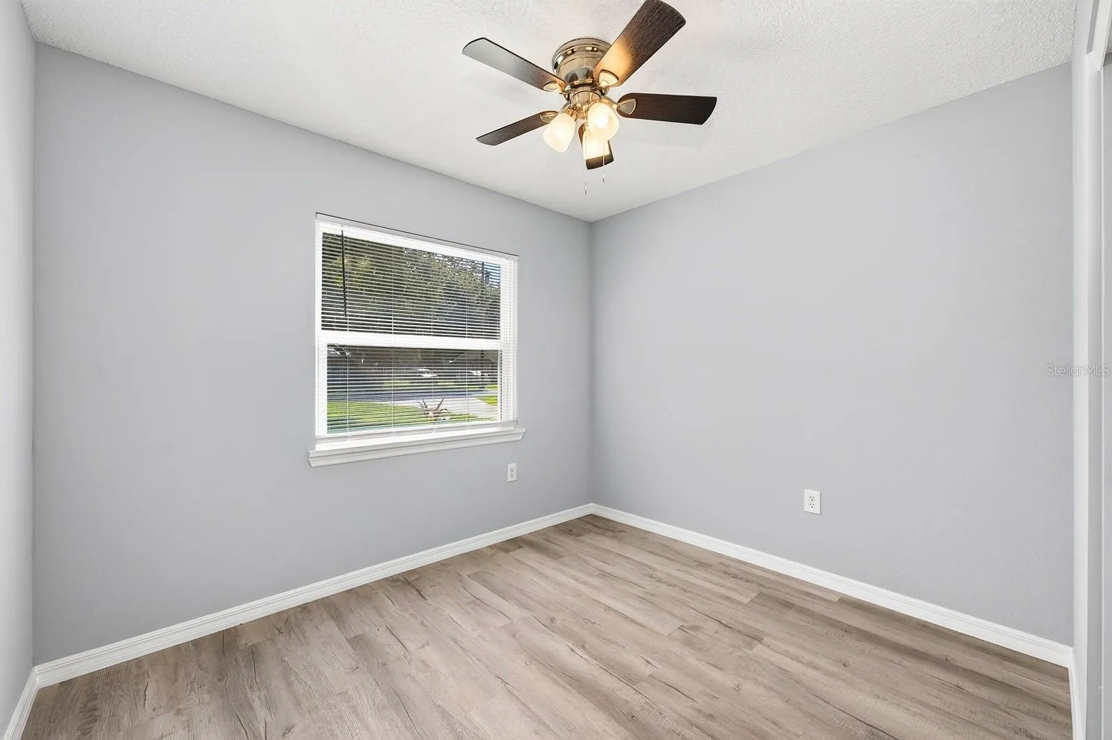 Guest bedroom 2 with a ceiling fan.