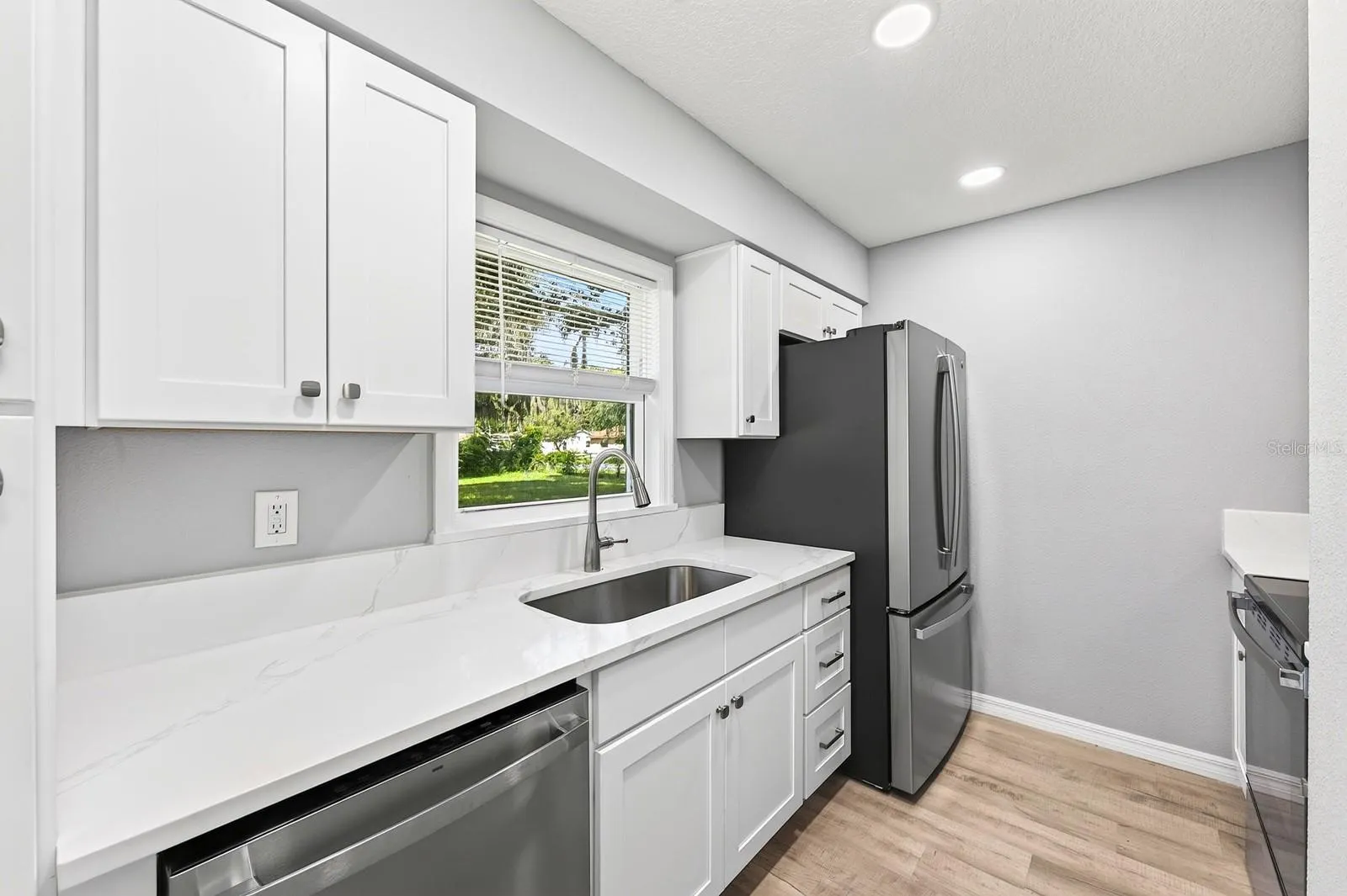 Completely updated kitchen with beautiful white stone counters.