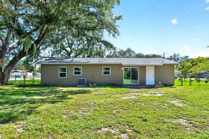 Back of home with access to the garage and dining room