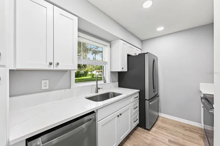 Completely updated kitchen with beautiful white stone counters.
