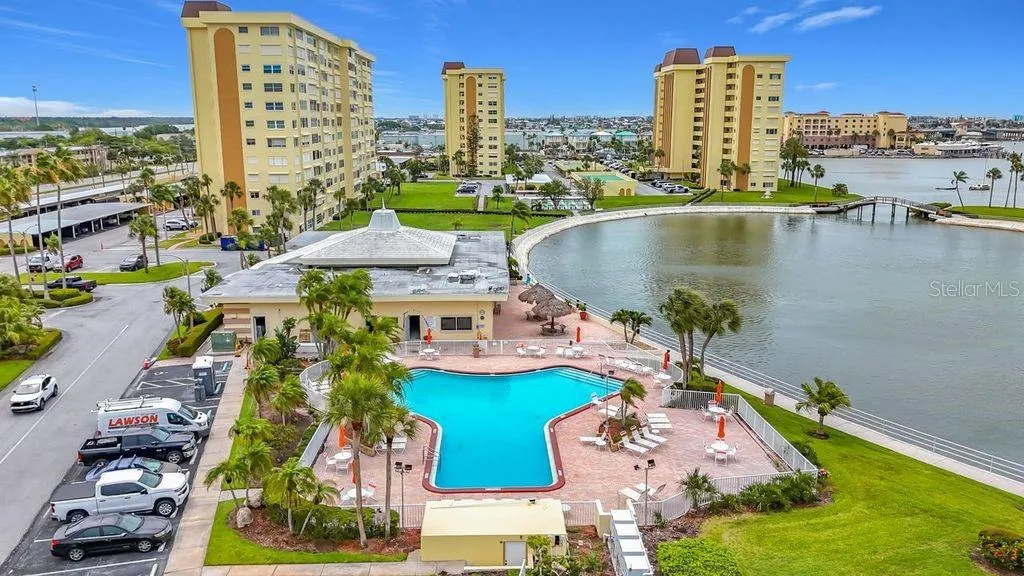Resort-style community view featuring the Washington building, tennis and pickleball courts, and sparkling pool- all nestled around the tranquil bayou