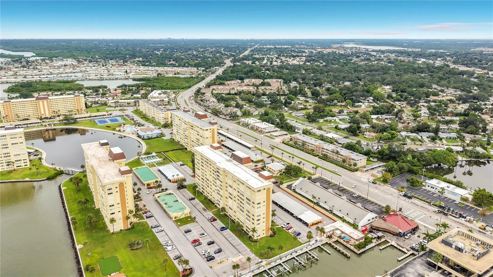 Resort-style community view featuring the Washington building, tennis and pickleball courts, and sparkling pool- all nestled around the tranquil bayou