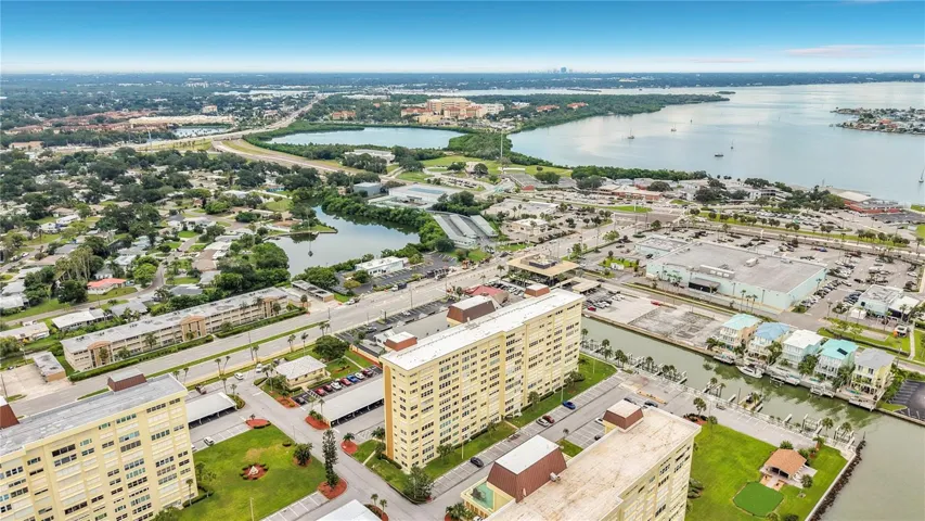 Resort-style community view featuring the Washington building, tennis and pickleball courts, and sparkling pool- all nestled around the tranquil bayou
