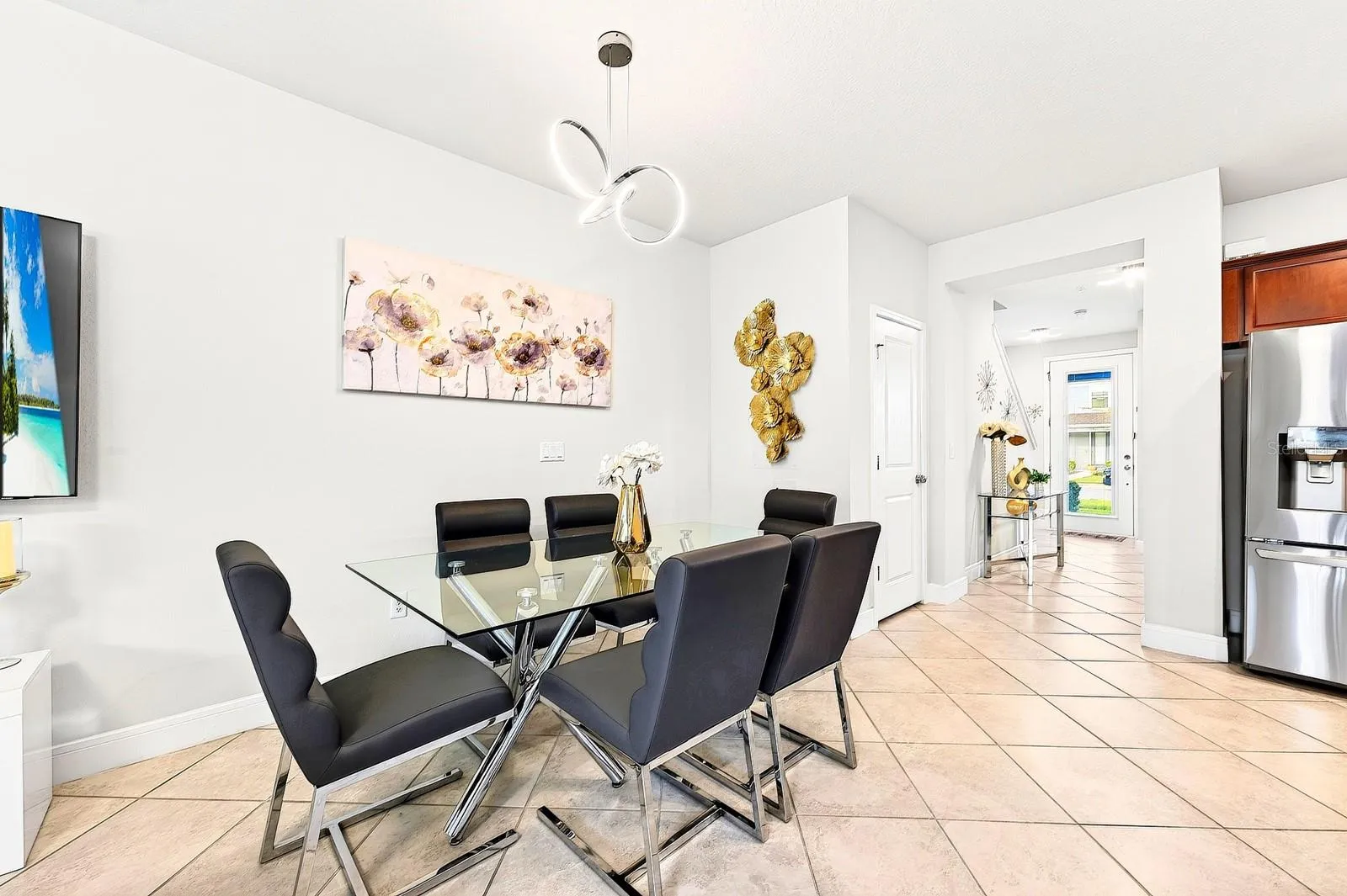 Upgraded light fixture in dining room with clear view to the front door