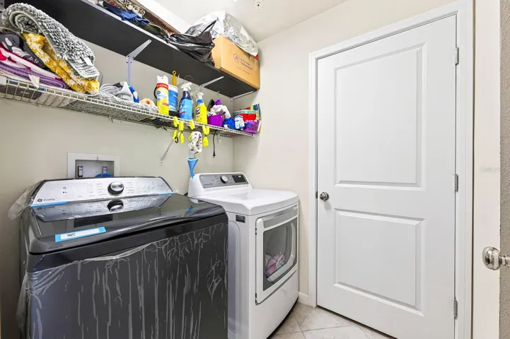 Laundry room features built-in shelves. Washer and Dryer CONVEY!