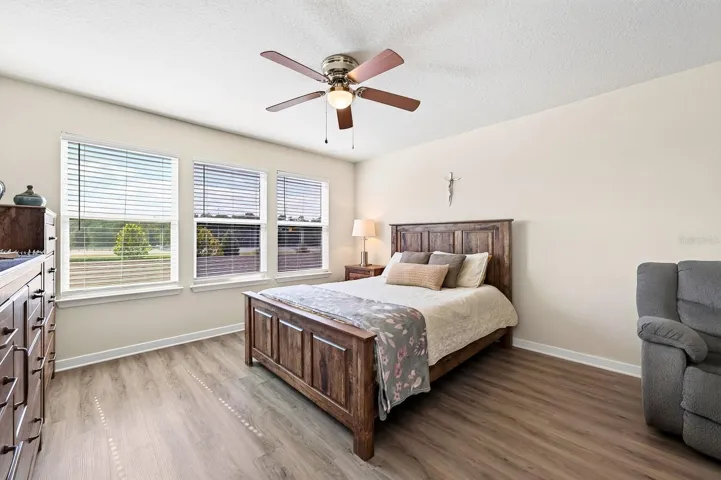 Primary Suite with 3 WINDOWS and a ceiling fan
