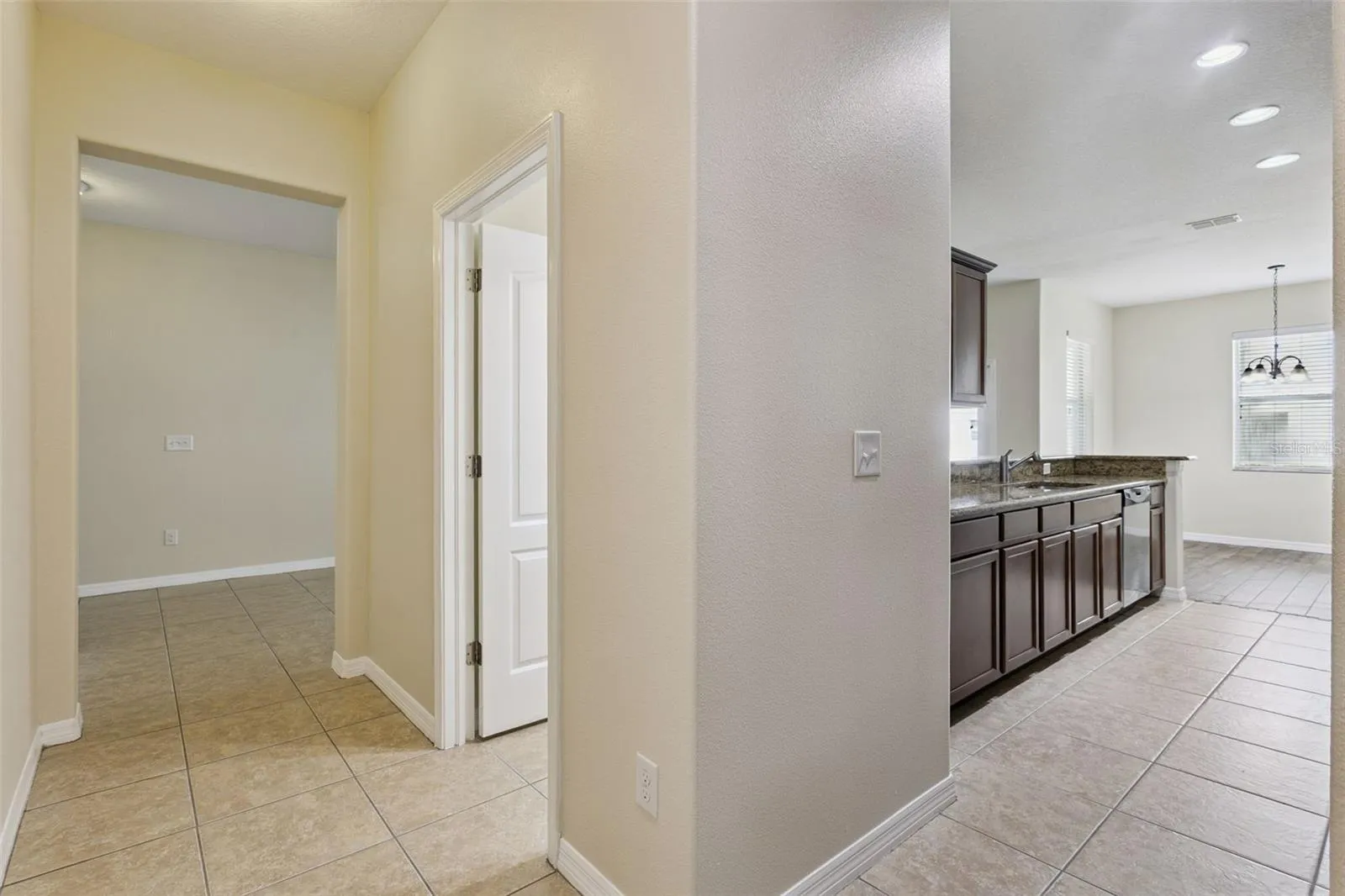 Hallway to half bath, garage and large hall closet