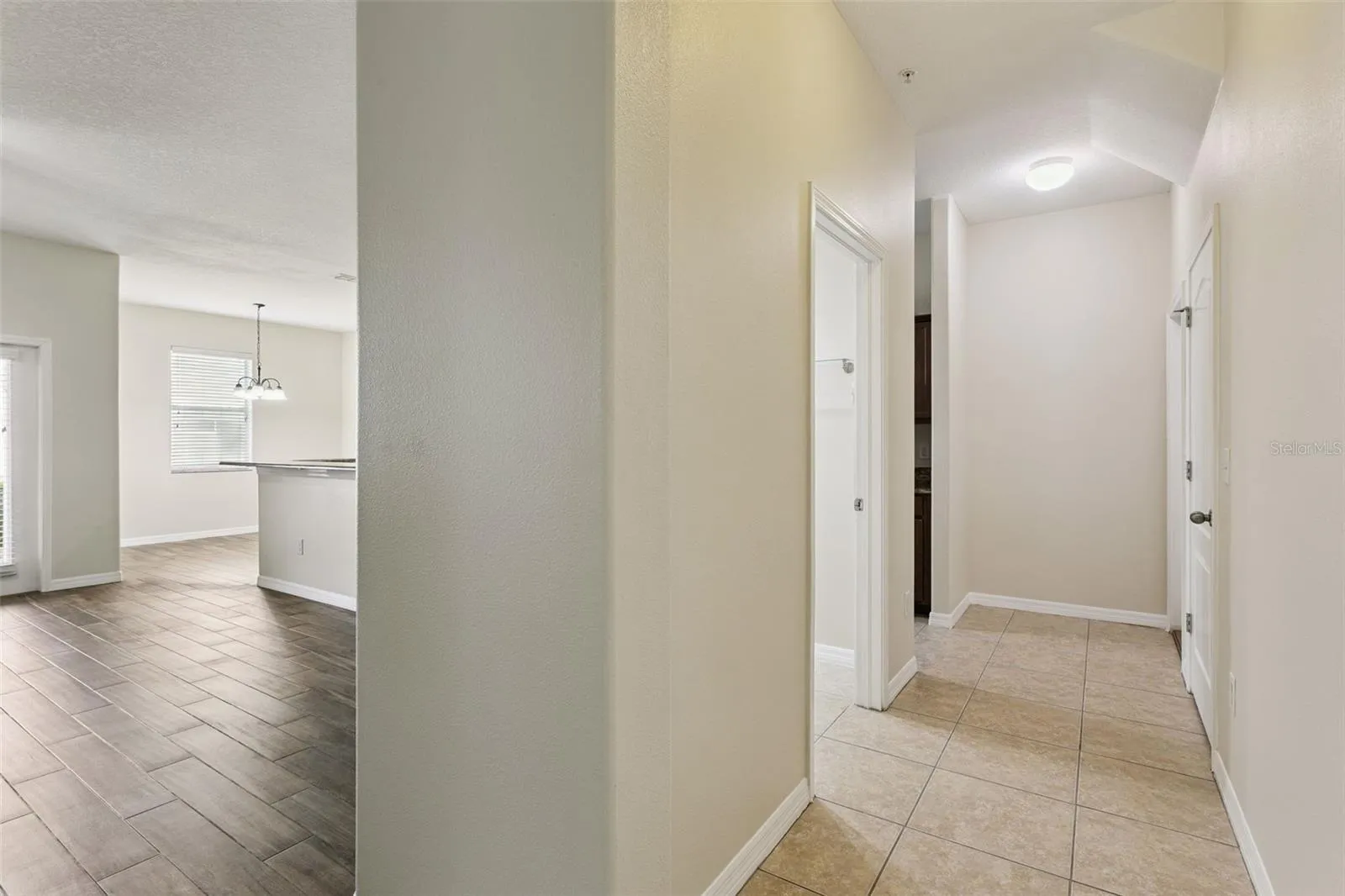 Hallway to half bath, large storage closet, garage and additional kitchen entry/exit