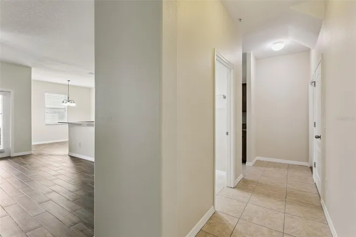Hallway to half bath, large storage closet, garage and additional kitchen entry/exit