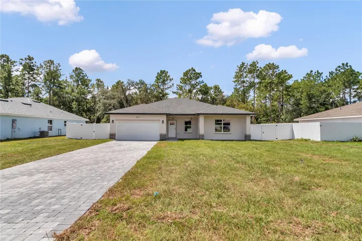 New construction on an oversized lot with paver driveway and attached 2-car garage