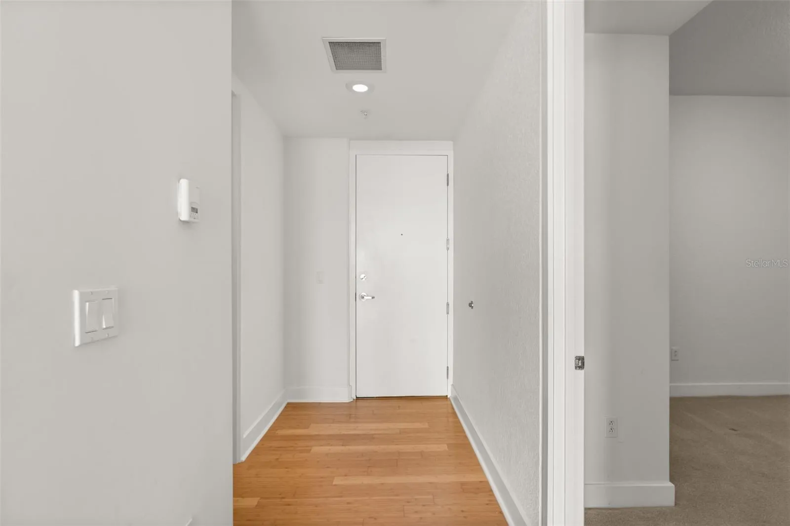 View of front door from inside unit