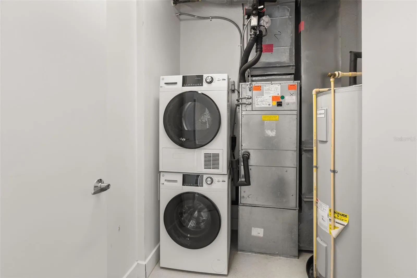 In-unit laundry room with stackable washer and dryer