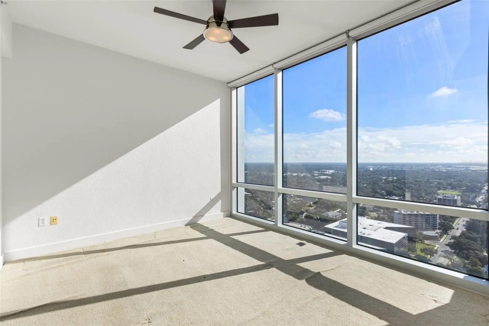 Primary bedroom with floor to ceiling windows