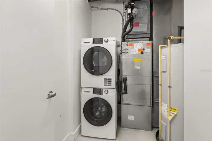 In-unit laundry room with stackable washer and dryer