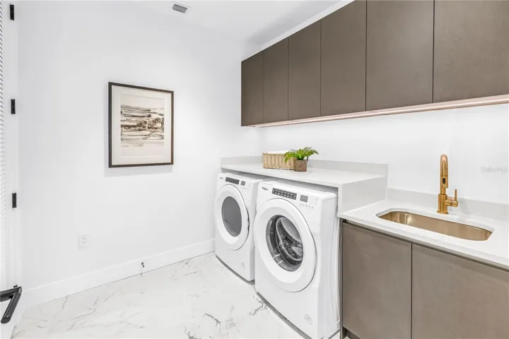laundry room, additional closet for storage , laundry sink and upper cabinets