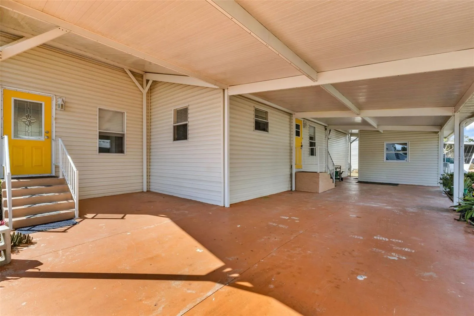 Nice long covered carport and large shed.
