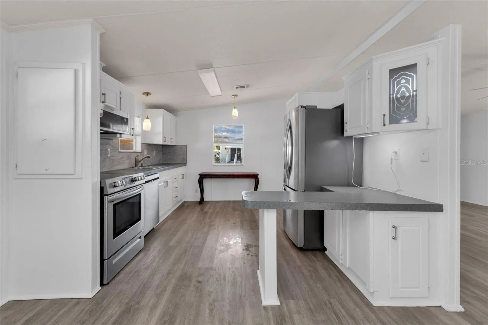 Kitchen with stainless steel appliances and a nice little bar area.