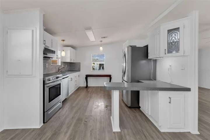 Kitchen with stainless steel appliances and a nice little bar area.