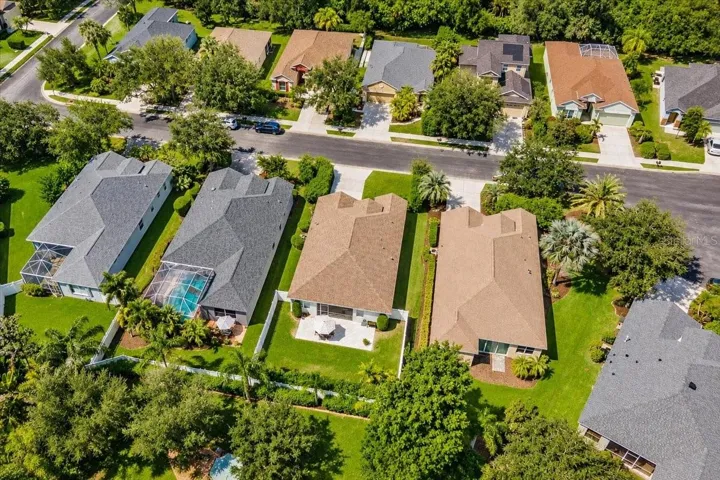 Fully fenced private yard, extended paver brick patio behind screened in lanai.