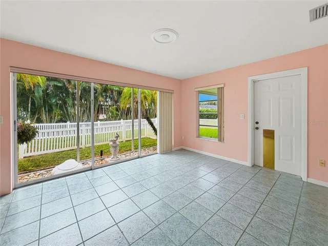 Large Family Room with Screened Garden Feature and Entrance to Large Covered Patio