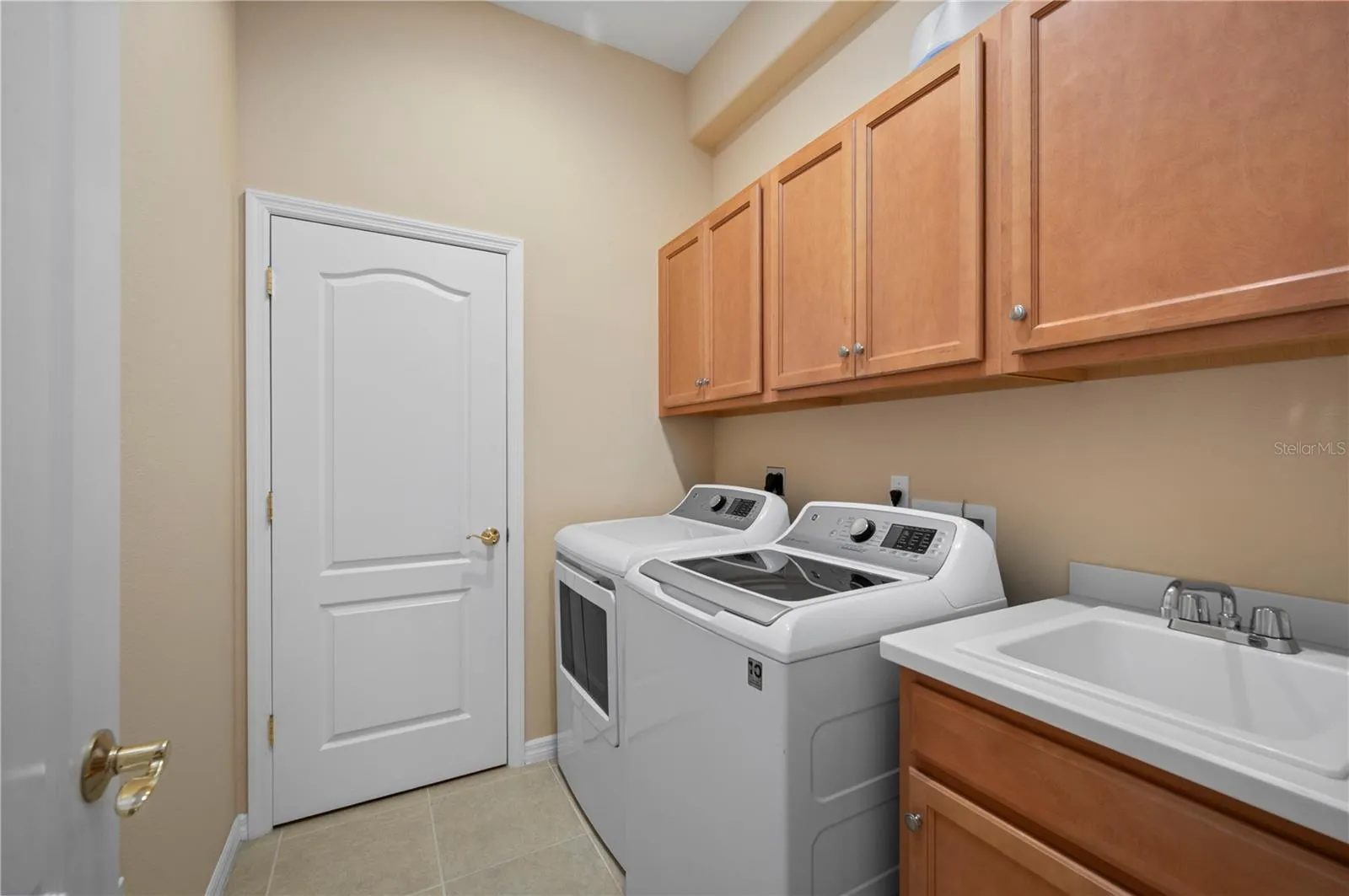 Laundry Room has extra storage closet, sink