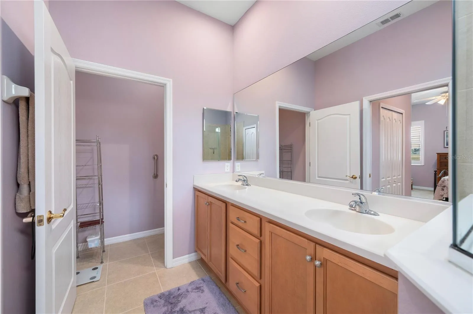 Ensuite bath has pass-through linen closet