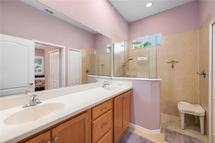 Ensuite bath has dual sinks, corian counters