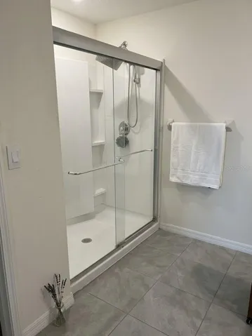 primary glass-enclosed walk-in shower