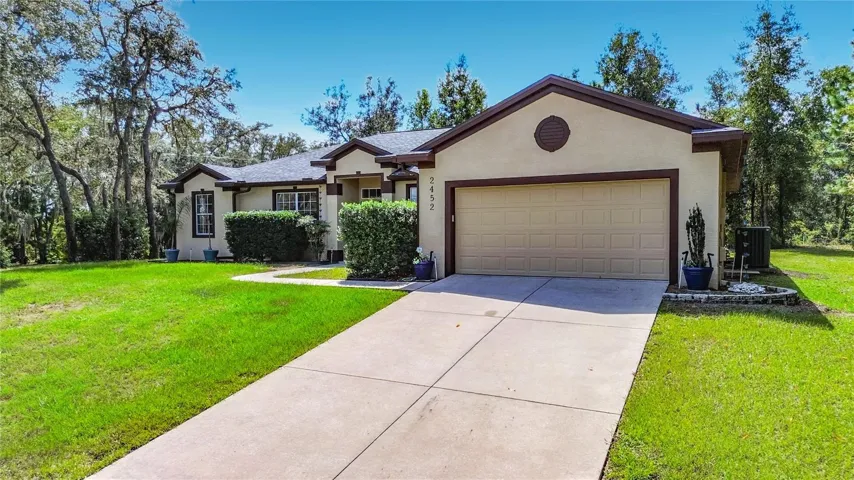 Welcoming Citrus Springs home with 2-car garage and lush green lawn