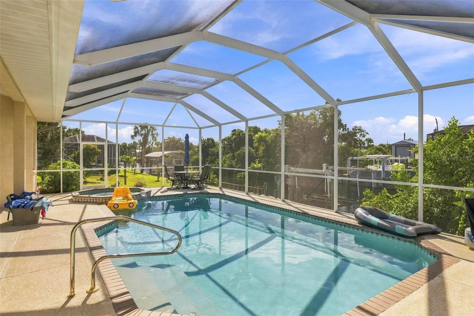 inviting pool with spillover spa hot tub