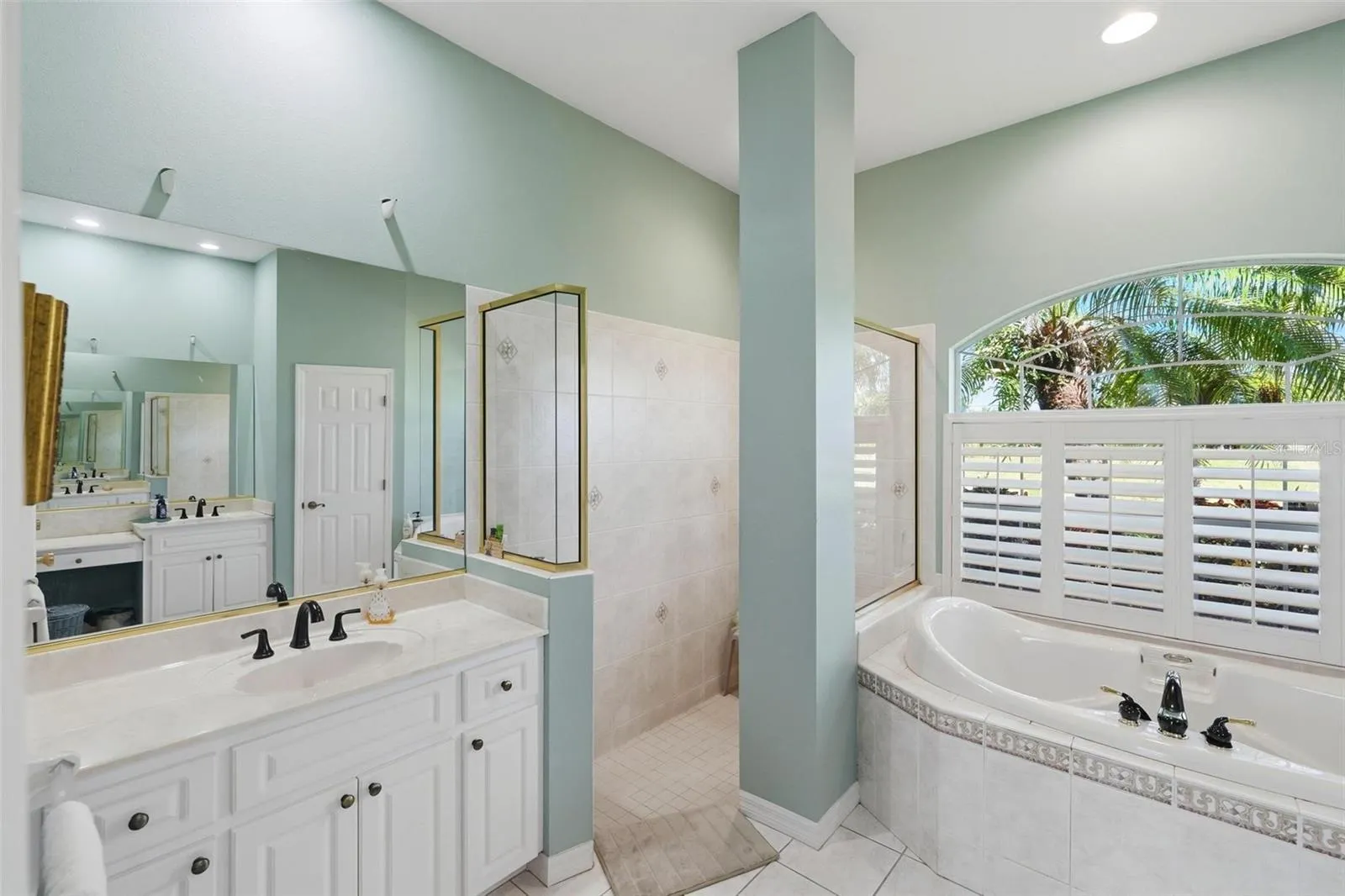 Separate, dual sink vanities, walk-in shower and spa bathtub.
